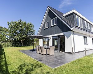 Villa 37a in De Koog, Texel with spacious terrace and green garden, ideal for a vacation home on the Wadden Islands.