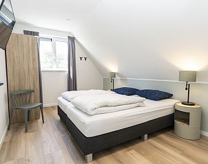 Cozy bedroom in Villa 37a, De Koog, Texel, vacation home with cozy decor and lots of natural light.