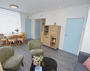 Spacious living room in Plevierstraat 18 vacation home, De Koog, Texel with sitting area and dining area.