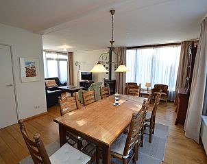 Cozy dining area in Orchismient 35 vacation home, De Koog Texel, with lots of natural light.