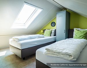 Attractive bedroom with two single beds in Type 3B vacation home, De Koog, Texel, with skylight for extra light.