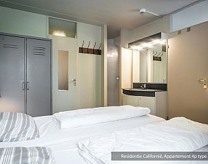 Master bedroom in Type 3B vacation home, De Koog, Texel, with double bed and modern sink.