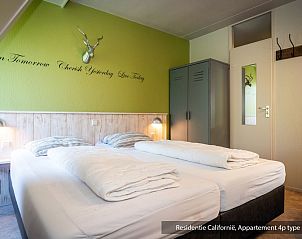 Cozy bedroom in Type 3B vacation home, De Koog, Texel, with comfortable beds and inspiring wall decoration.