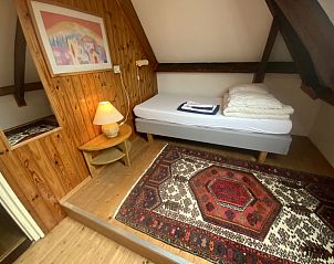 Cozy single room in Voorhuis vacation home De Koog Texel with wooden walls.