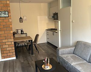 Dining and living space in Apartment Kerckeland 40, De Koog, Texel with open kitchen.