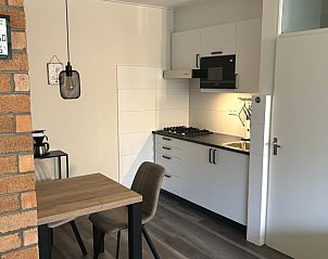 Stylish kitchen in Apartment Kerckeland 40, De Koog, Texel with dining area.