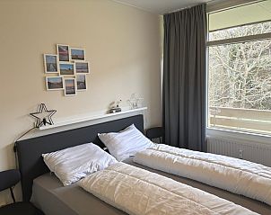 Bright bedroom in Apartment Kerckeland 40, De Koog, Texel with a view of nature.