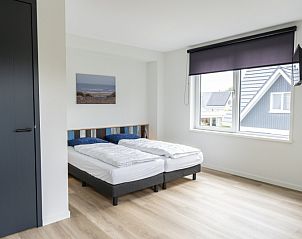 Bright bedroom with view in Villa 37, De Koog, Texel. Vacation home on the Wadden Islands.