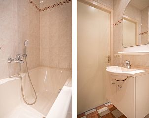 Badezimmer von Bungalow 31 in De Koog, Texel mit komfortabler Badewanne und modernen Annehmlichkeiten fr einen luxurisen Urlaub.