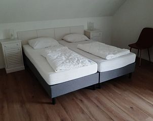 Modern kitchen in Cottage in De Koog, Texel, with sleek gray cabinets and a beautiful view.