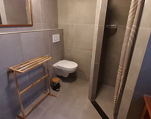 Cozy corner with closet and chair in Cottage in De Koog, Texel, ideal for relaxing moments.