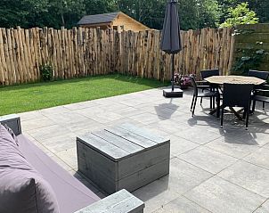 Spacious terrace with garden furniture and views of nature at Cottage in De Koog, Texel.