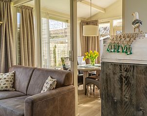 Bright living room of De Anemoon in De Koog, Texel, with comfortable seating and decoration.