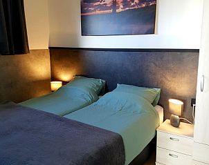 Attractive bedroom in vacation home De Anemoon in De Koog, Texel, with comfortable beds.