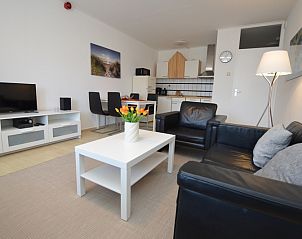 Stylish interior space of Apartment Kerckeland 98, De Koog, Texel with dining and sitting area for a relaxing stay.