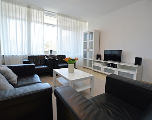 Bright living room in Apartment Kerckeland 98, De Koog, Texel with large windows and an inviting atmosphere.
