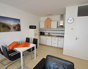 Functional kitchen in Apartment Kerckeland 98, De Koog, Texel with modern appliances and a cozy dining area.