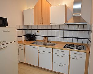 Fully equipped kitchen in Apartment Kerckeland 98, De Koog, Texel with modern amenities and a cozy atmosphere.