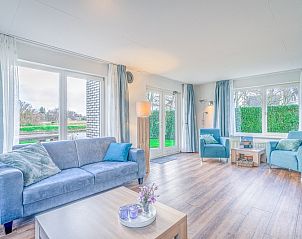 Bright living room of Holiday home Honeysuckle 55 in De Koog Texel overlooking the garden.