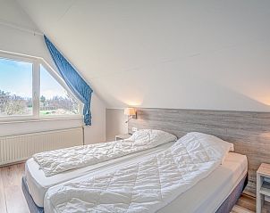 Welcoming bedroom in Holiday home Honeysuckle 55 on Texel with lots of natural light.