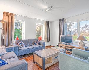Cozy living room of Holiday Home Honeysuckle 51 in De Koog, Texel, with comfortable seating and plenty of natural light.