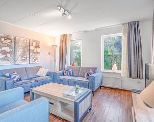 Stylish living room in Holiday Home Honeysuckle 51, De Koog, Texel, with art on the wall and lots of natural light.
