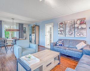 Open living space in Holiday Home Honeysuckle 51, De Koog, Texel, with comfortable sitting area and dining area.