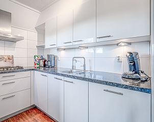 Modern kitchen in Holiday home Honeysuckle 51, De Koog, Texel, with sleek white cabinets and high-end appliances.