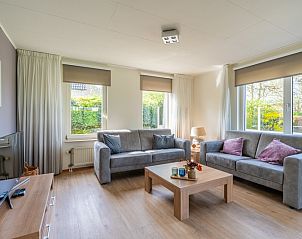 Cozy living room of Holiday Home Honeysuckle 63 in De Koog, Texel with comfortable sofas.