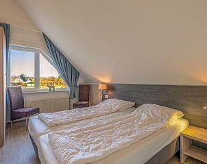 Comfortable bedroom in Holiday home Honeysuckle 63, De Koog, Texel with views of the surroundings.