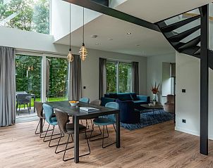 Spacious interior of vacation home Grutto 16 in De Koog, Texel, with modern interior and views of the green surroundings.