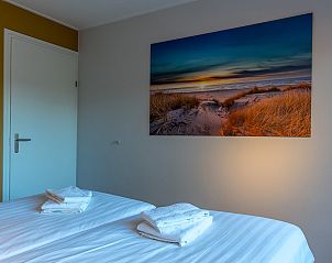 Second bedroom in Zilte Bries vacation home, De Koog, Texel, with art and window.