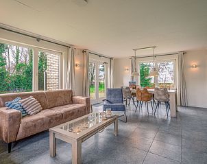 Dining room in Holiday Home Honeysuckle 45, De Koog, Texel, with large dining table and lots of light.