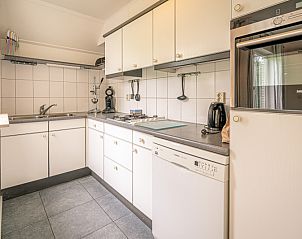 Bedroom with double bed in Holiday home Kamperfoelie 45, De Koog, Texel, overlooking the garden.