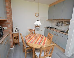 Dining area and kitchen of Apartment Kerckeland 20 in De Koog, Texel with cozy furnishings.