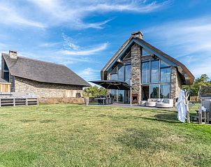 Villa 187 with Hot tub in De Koog, Texel offers a spacious terrace with modern architecture and stunning views of the Wadden Islands.