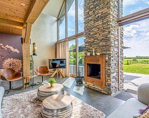 Villa 187 with Hot tub in De Koog, Texel offers a spacious living room with a fireplace and beautiful views of the nature of the Wadden Islands.