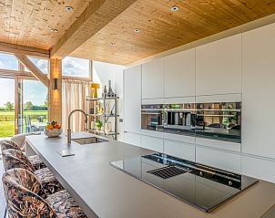Modern kitchen in Villa 187 with Hottub, De Koog, Texel with luxury appliances and views of the serene surroundings of the Wadden Islands.