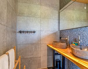 Stylish bathroom in Villa 187 with Hottub, De Koog, Texel with modern sinks and elegant finish on the Wadden Islands.