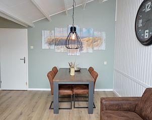 Dining area with four chairs in Motel Texel - Apartment 314/1S, De Koog, Texel, ideal for family dinners.