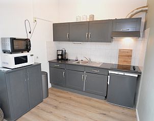 Fully equipped kitchen in Motel Texel - Apartment 314/1S, De Koog, Texel, with oven and refrigerator.