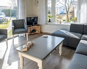 Interior of Chalet Bregkoog 207, Texel with comfortable seating area.