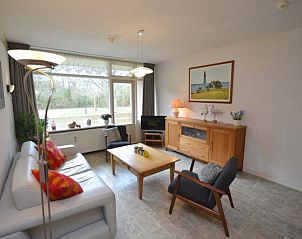 Bright living room of Apartment Kerckeland 16 in De Koog, Texel with large windows and views of nature.