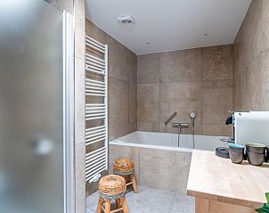 Luxury bathroom with bathtub and modern amenities in Cottage in De Koog, Texel, Wadden Islands.