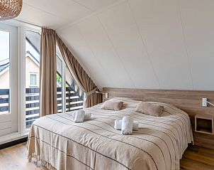 Bedroom with balcony in Cottage in De Koog, Texel, Wadden Islands.