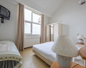 Bright bedroom in Resort De Buteriggel Apartment 1 overlooking Texel nature, De Koog.