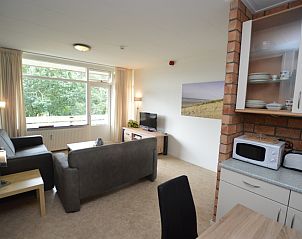 Cozy living room in Apartment Kerckeland 122, De Koog, Texel overlooking greenery.