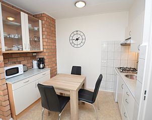 Dining area and kitchen of Apartment Kerckeland 122 on Texel with practical layout.
