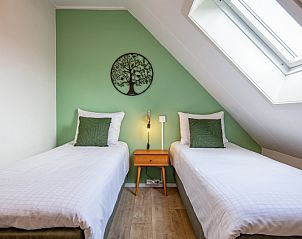 Bright bedroom with two single beds in De Boomleeuwerik vacation home, De Koog, Texel.