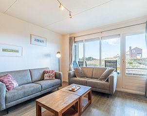 Spacious living room of Apartment Juliana 046 Island and Sea View, De Koog, Texel with modern furnishings and views of nature.